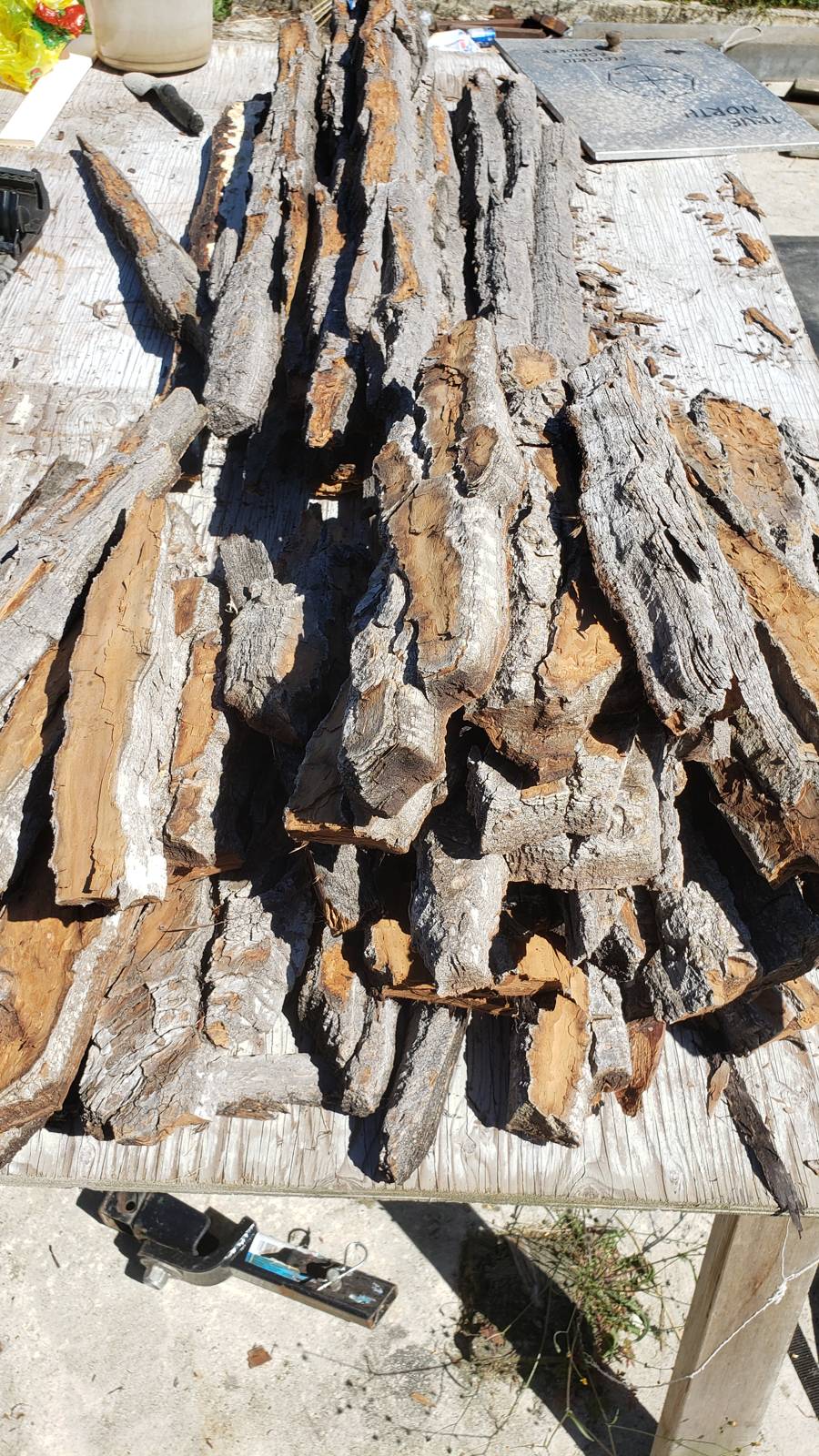 A table piled with thick, deeply furrowed cottonwood bark
